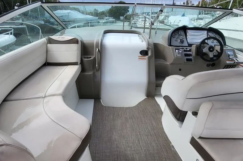 Slide: The Image of Interior of a 2008 Cruisers 330 boat with seating and control panel. - 11