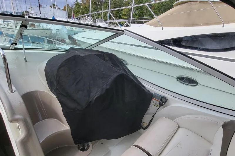 Slide: The Image of Interior of a 2008 Cruisers 330 boat with covered controls and seating area. - 21