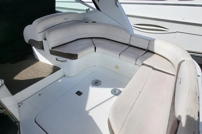 Slide: The Image of 2008 Cruisers 330 boat interior with white cushioned seating area. - 17