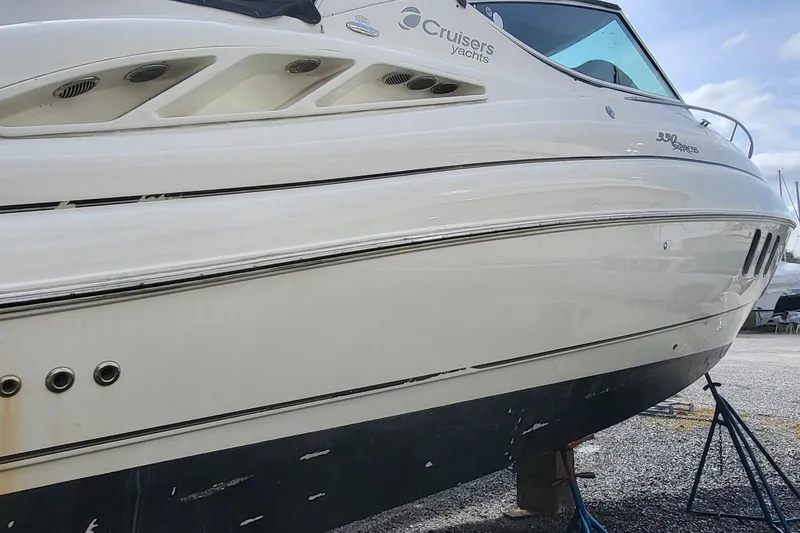 Slide: The Image of 2008 Cruisers 330 yacht on dry dock, showcasing sleek design and hull details. - 3