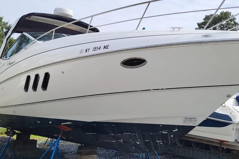 Slide: The Image of 2008 Cruisers 330 yacht on stands, white hull, registration NY 1914 ME. - 4