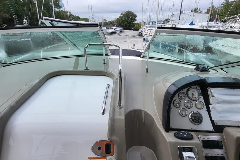 Slide: The Image of 2008 Cruisers 330 boat dashboard with gauges and controls, docked at marina. - 8