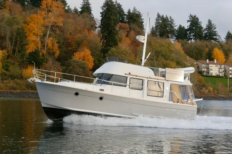 The Image of 2013 Beneteau Swift Trawler 34 Fly cruising on a scenic autumn lake. - 0