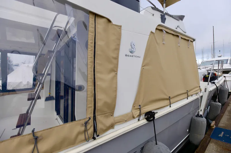 Slide: The Image of Helm of 2013 Beneteau Swift Trawler 34 Fly with navigation equipment and wooden steering wheel. - 17