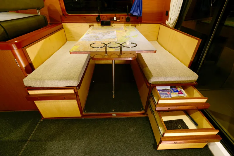 Slide: The Image of 2013 Beneteau Swift Trawler 34 Fly interior with seating and wooden steps. - 29