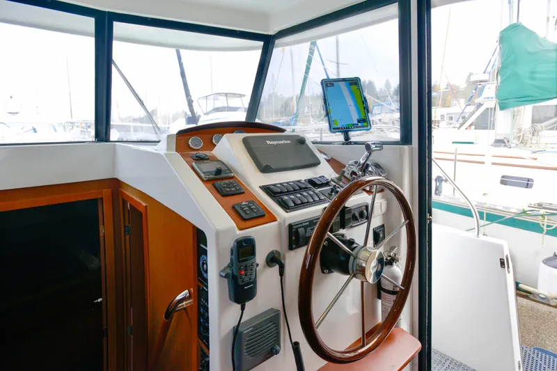 Slide: The Image of 2013 Beneteau Swift Trawler 34 Fly docked with beige canvas cover. - 32