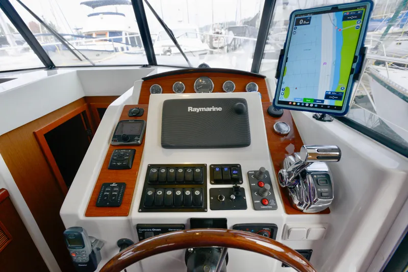 Slide: The Image of 2013 Beneteau Swift Trawler 34 Fly docked among other boats in a marina. - 33