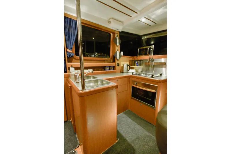 Slide: The Image of Flybridge view of 2013 Beneteau Swift Trawler 34 in a marina setting. - 35