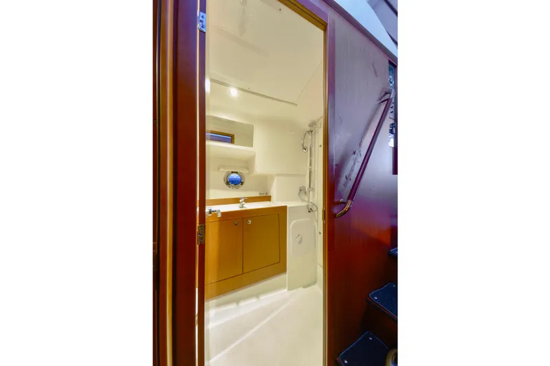 Slide: The Image of 2013 Beneteau Swift Trawler 34 Flybridge with marina view, featuring helm seat and table. - 36
