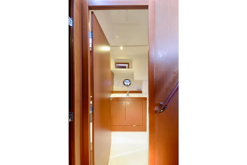 Slide: The Image of 2013 Beneteau Swift Trawler 34 Fly with inflatable boat on deck, docked in marina. - 37