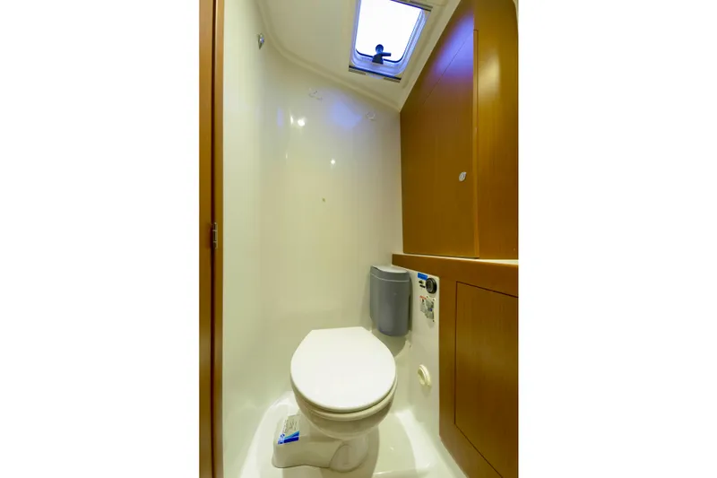 Slide: The Image of 2013 Beneteau Swift Trawler 34 Fly with inflatable dinghy on deck, docked at marina. - 38