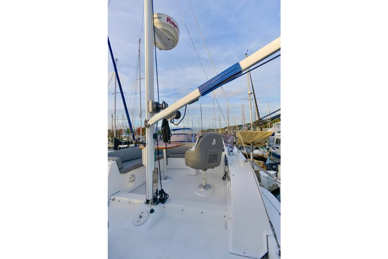 Slide: The Image of 2013 Beneteau Swift Trawler 34 Fly docked at marina, surrounded by trees. - 6