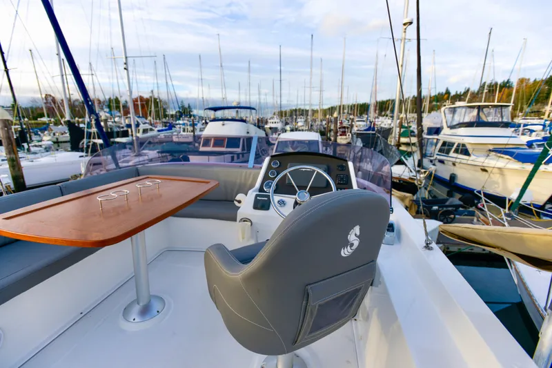 Slide: The Image of 2013 Beneteau Swift Trawler 34 Fly docked at marina, front view. - 7