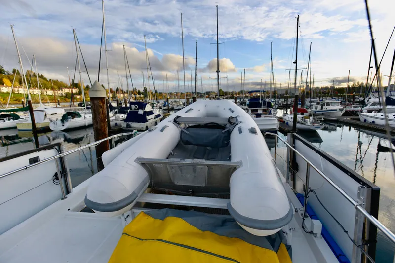 Slide: The Image of 2013 Beneteau Swift Trawler 34 Fly moored in a marina, surrounded by other boats. - 8