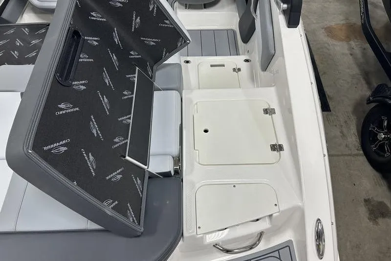 Slide: The Image of 2026 Chaparral 21 SSi boat interior with open storage compartments and seating. - 14