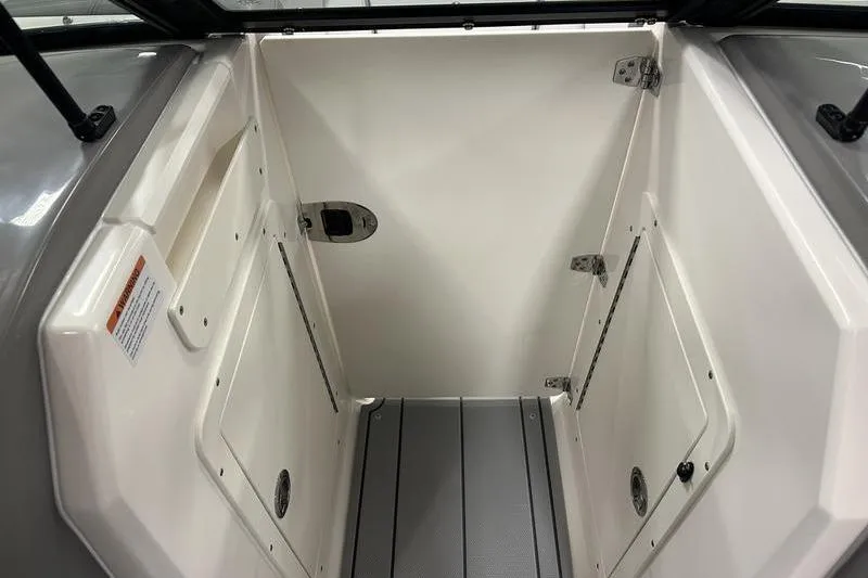 Slide: The Image of Interior view of 2026 Chaparral 21 SSi boat storage compartment with white finish. - 22
