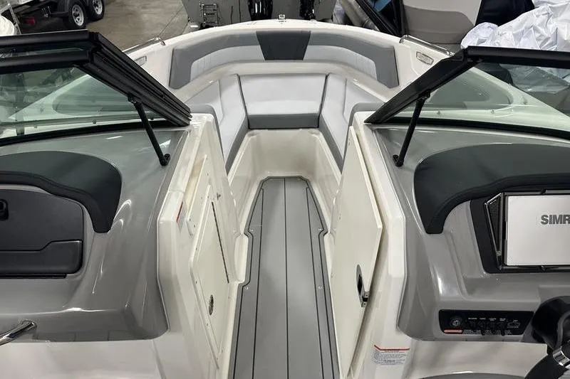 Slide: The Image of 2026 Chaparral 21 SSi boat interior with gray and white seating and dashboard. - 23