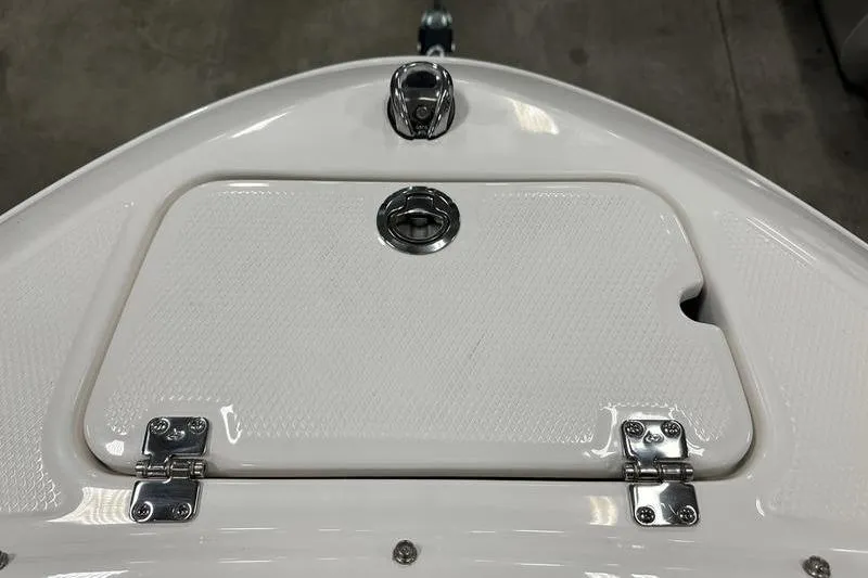 Slide: The Image of 2026 Chaparral 21 SSi boat hatch with chrome fittings and textured surface. - 27