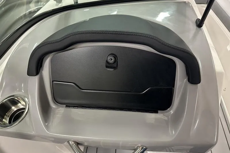 Slide: The Image of 2026 Chaparral 21 SSi boat dashboard with glove compartment and cup holder. - 28