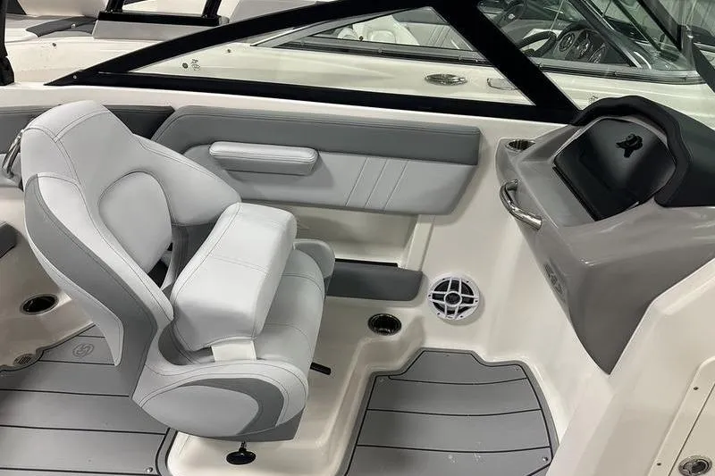 Slide: The Image of 2026 Chaparral 21 SSi boat interior with gray seating and modern dashboard design. - 29