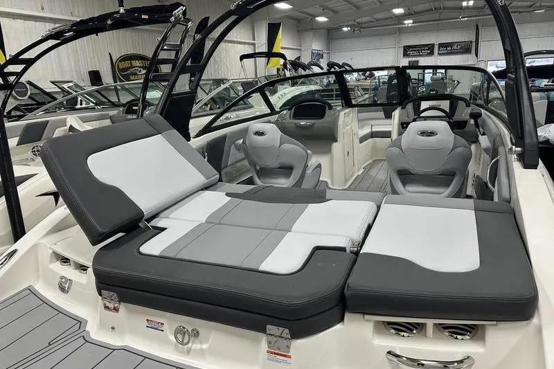 Slide: The Image of 2026 Chaparral 21 SSi boat interior with gray seating and modern design in showroom. - 7