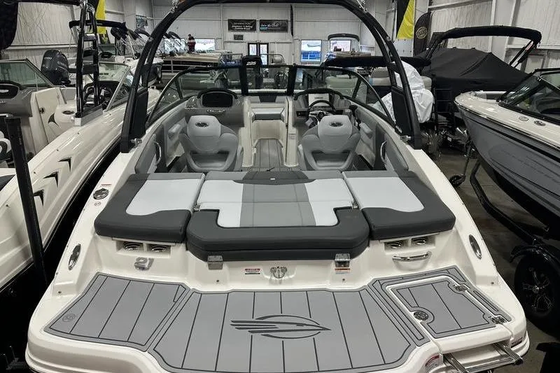 Slide: The Image of 2026 Chaparral 21 SSi boat interior with gray seating and sleek design in showroom. - 8