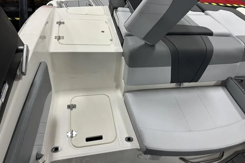 Slide: The Image of 2026 Chaparral 21 SSi boat interior with gray seating and storage compartments. - 9