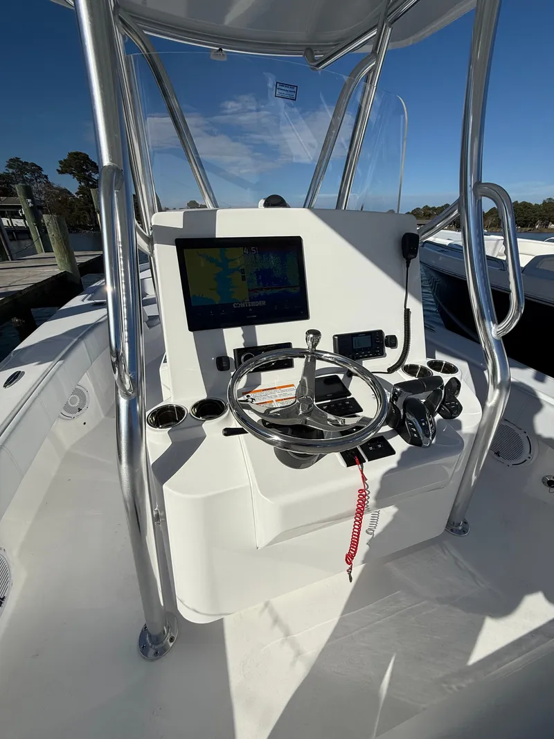 Slide: The Image of 2026 Contender 29 Bay boat console with steering wheel and navigation display. - 11