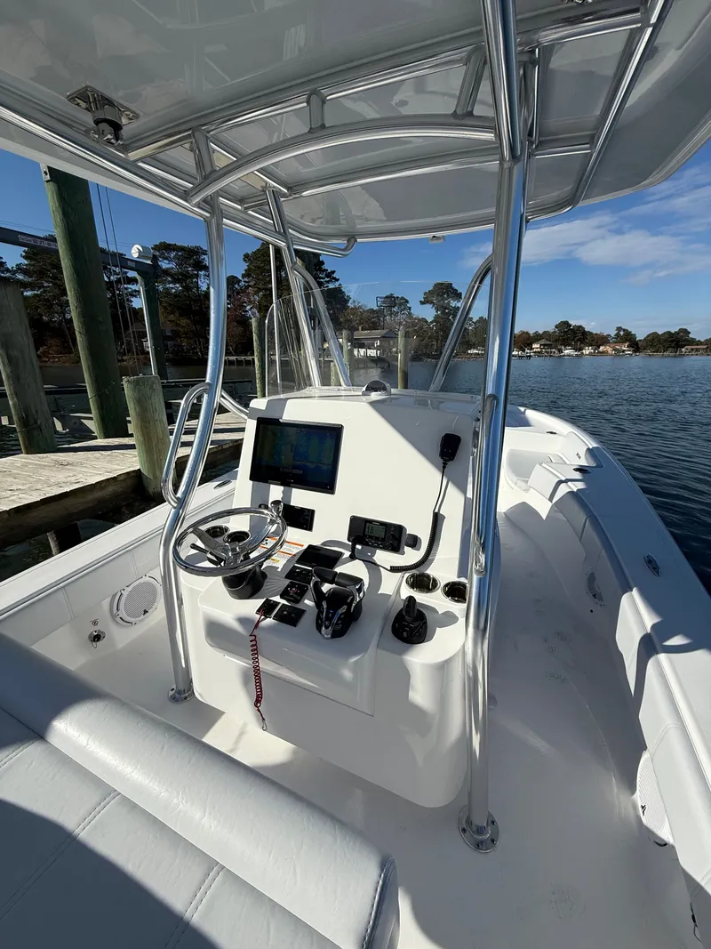 Slide: The Image of 2026 Contender 29 Bay boat cockpit with steering wheel and navigation equipment. - 12