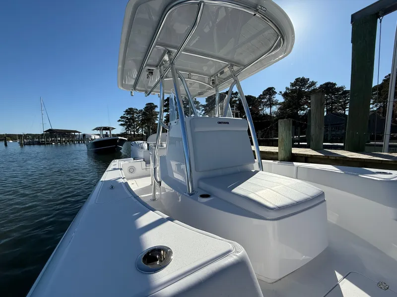 Slide: The Image of 2026 Contender 29 Bay boat docked, featuring sleek design and spacious seating. - 16