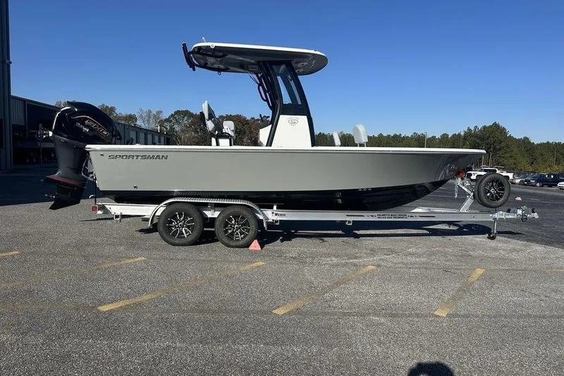 The Image of 2026 Sportsman Masters 227 Bay Boat on trailer, parked outdoors under clear blue sky. - 0