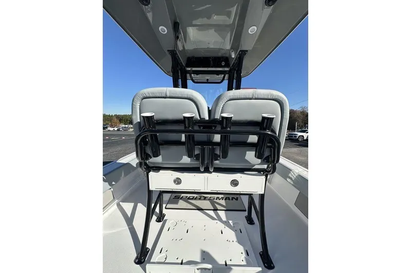 Slide: The Image of 2026 Sportsman Masters 227 Bay Boat interior with dual seats and rod holders. - 10