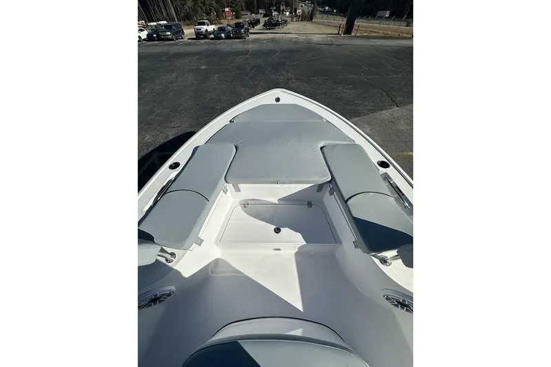 Slide: The Image of 2026 Sportsman Masters 227 Bay Boat with cushioned seating and storage compartments. - 12