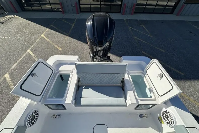 Slide: The Image of 2026 Sportsman Masters 227 Bay Boat with open storage compartments and seating. - 13