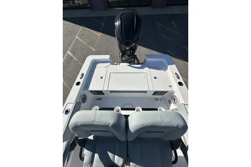 Slide: The Image of 2026 Sportsman Masters 227 Bay Boat interior with seating and motor, viewed from above. - 15