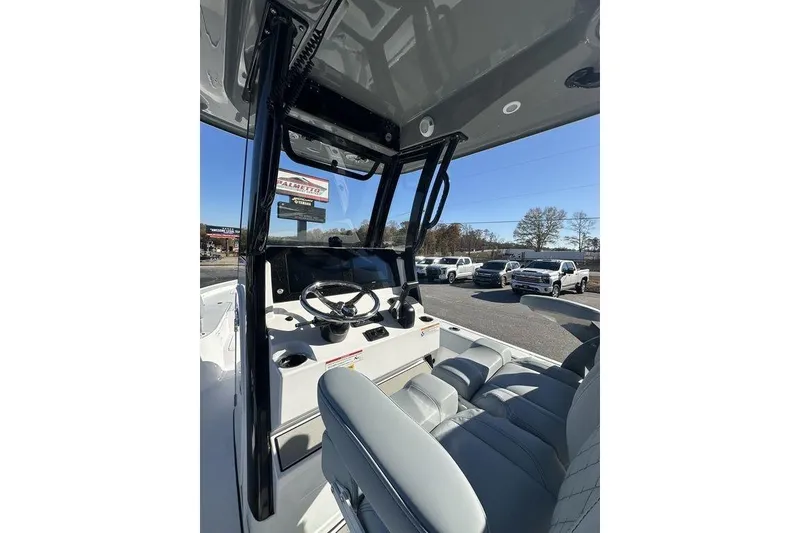 Slide: The Image of 2026 Sportsman Masters 227 Bay Boat interior with steering wheel and seating. - 2