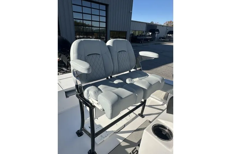 Slide: The Image of 2026 Sportsman Masters 227 Bay Boat with dual cushioned seats and armrests. - 3