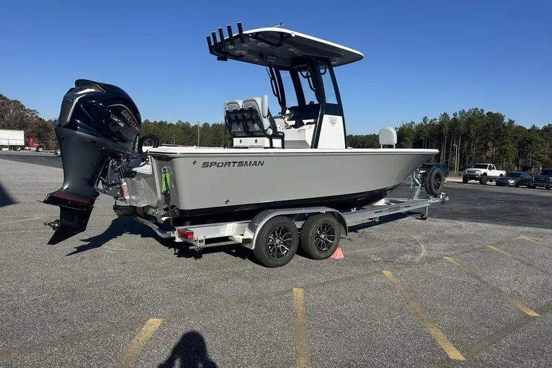 Slide: The Image of 2026 Sportsman Masters 227 Bay Boat on trailer, parked in a lot under clear blue sky. - 4