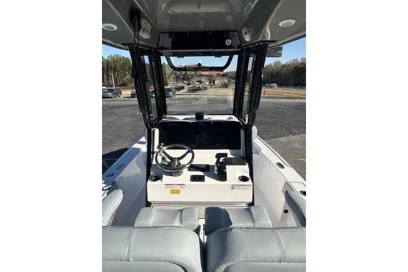 Slide: The Image of 2026 Sportsman Masters 227 Bay Boat interior with steering wheel and seating. - 6
