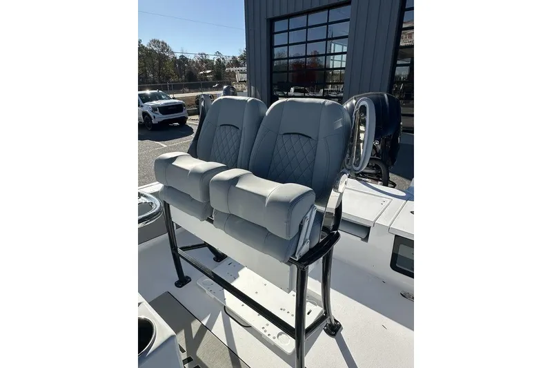 Slide: The Image of 2026 Sportsman Masters 227 Bay Boat with dual cushioned seats and sleek design. - 7