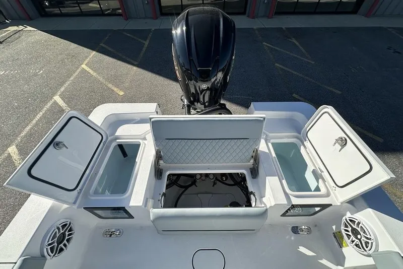 Slide: The Image of 2026 Sportsman Masters 227 Bay Boat with open storage compartments and motor, viewed from above. - 9