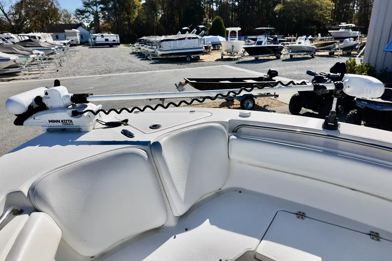 Slide: The Image of 2015 Sea Fox 246 Commander with Minn Kota trolling motor in a boatyard setting. - 13