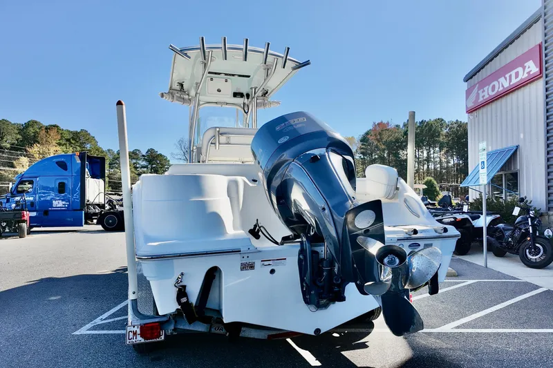 Slide: The Image of 2015 Sea Fox 246 Commander boat with outboard motor in a parking lot. - 17