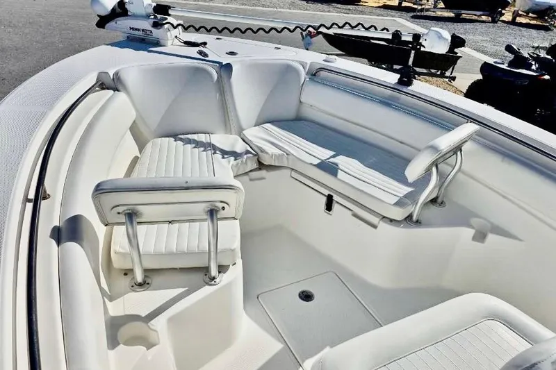 Slide: The Image of 2015 Sea Fox 246 Commander boat interior with white seating and fishing equipment. - 19