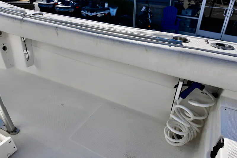 Slide: The Image of 2015 Sea Fox 246 Commander boat interior with coiled hose and rod holders. - 8