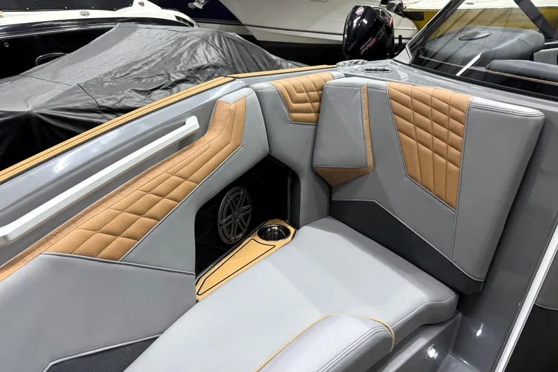 Slide: The Image of 2026 Nautique Super Air Nautique S21 interior with stylish gray and tan upholstery. - 11