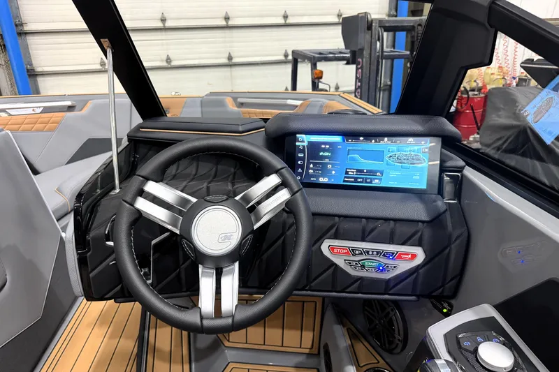 Slide: The Image of 2026 Nautique Super Air Nautique S21 dashboard with advanced touchscreen controls and steering wheel. - 12