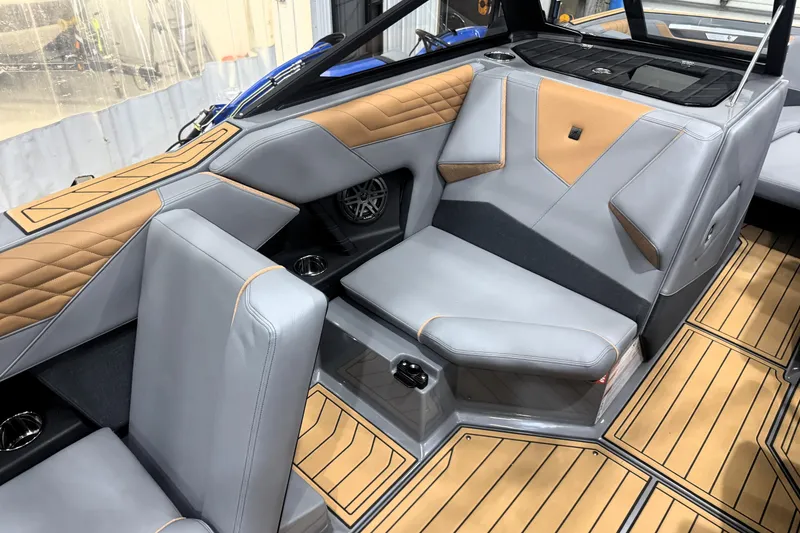 Slide: The Image of 2026 Nautique Super Air Nautique S21 interior with gray and tan seating, stylish design. - 22