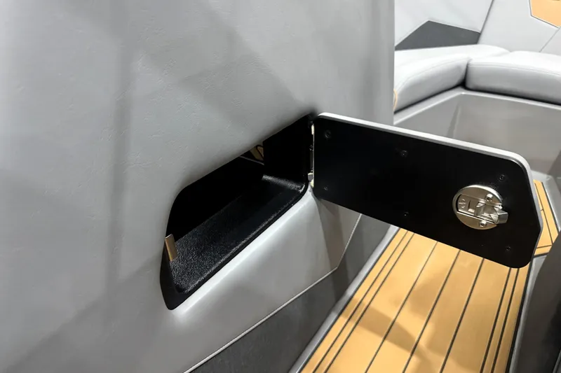 Slide: The Image of 2026 Nautique Super Air Nautique S21 interior storage compartment with sleek design and secure latch. - 24