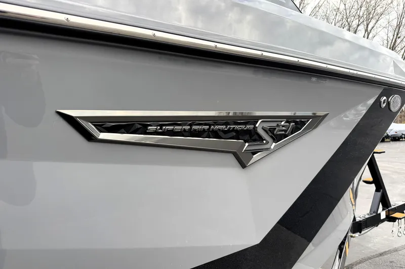 Slide: The Image of 2026 Nautique Super Air Nautique S21 boat emblem on sleek gray hull. - 32